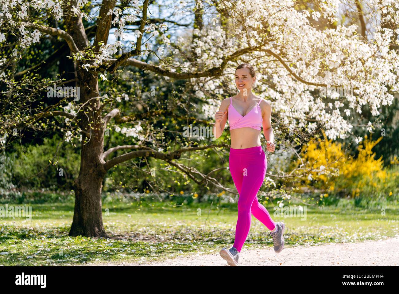 Woman running in spring park Stock Photo