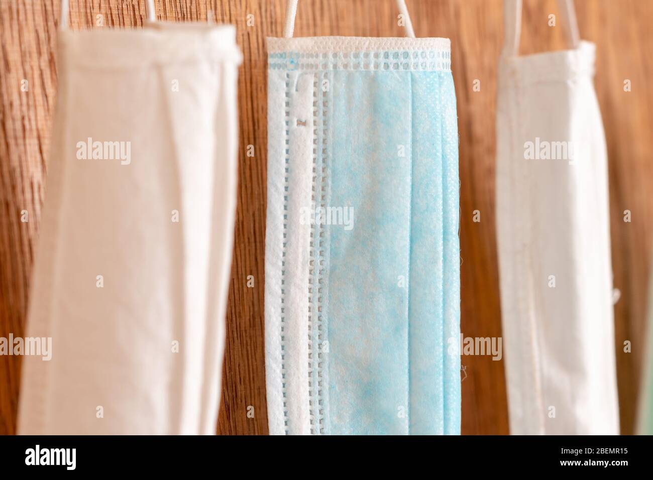 medical masks hanging in row close up background for protection from virus covid-19 coronavirus Stock Photo