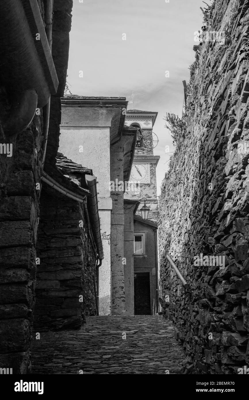 old alpine village built on top of a mountain. Bell towers,Houses and stone roofs Stock Photo