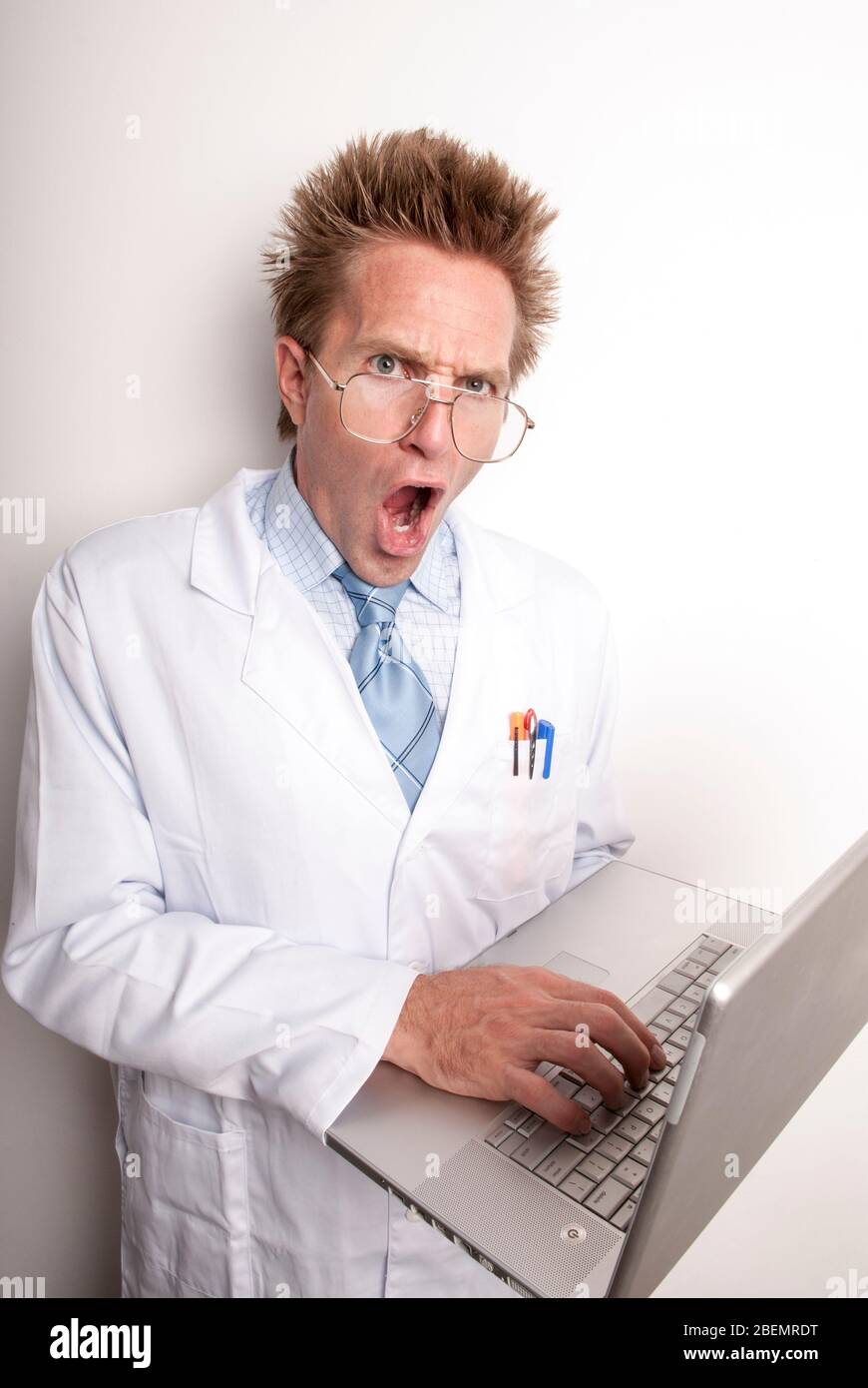 Mad scientist with crazy expression to match his hair looking at the