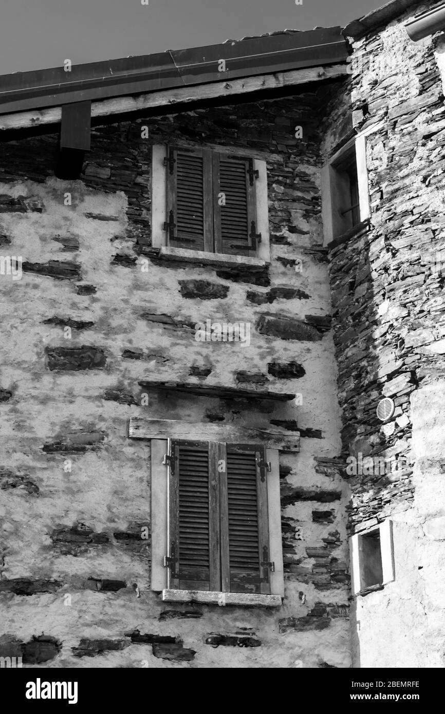 old alpine village built on top of a mountain. Bell towers,Houses and stone roofs Stock Photo