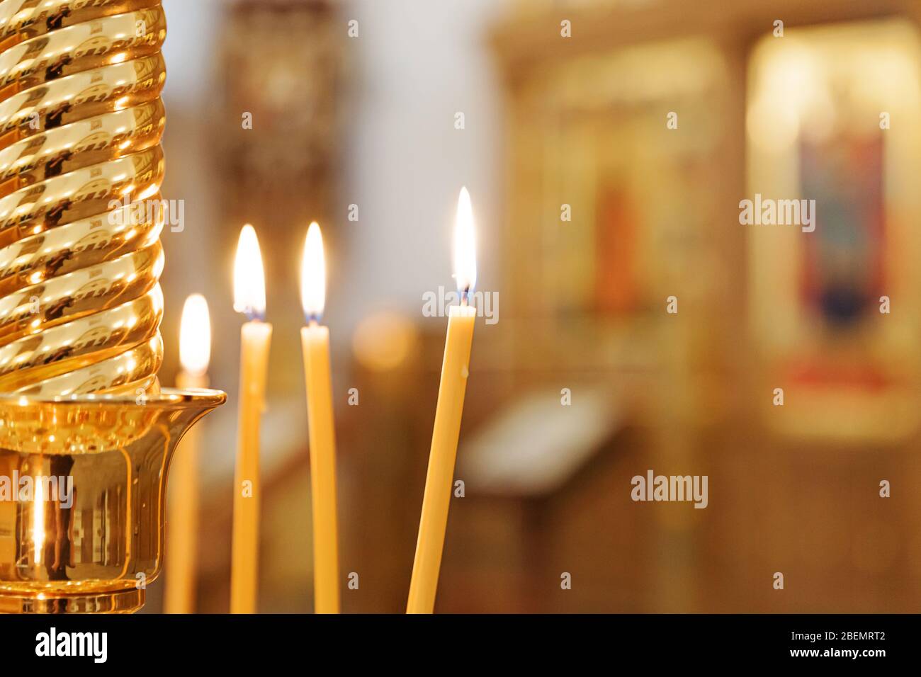 Orthodox Church. Christianity. Festive interior decoration with burning candles and icon in traditional Orthodox Church on Easter Eve or Christmas. Religion faith pray symbol Stock Photo