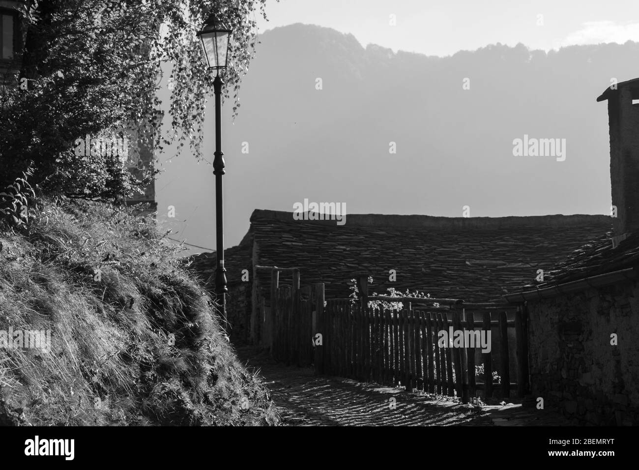 old alpine village built on top of a mountain. Bell towers,Houses and stone roofs Stock Photo