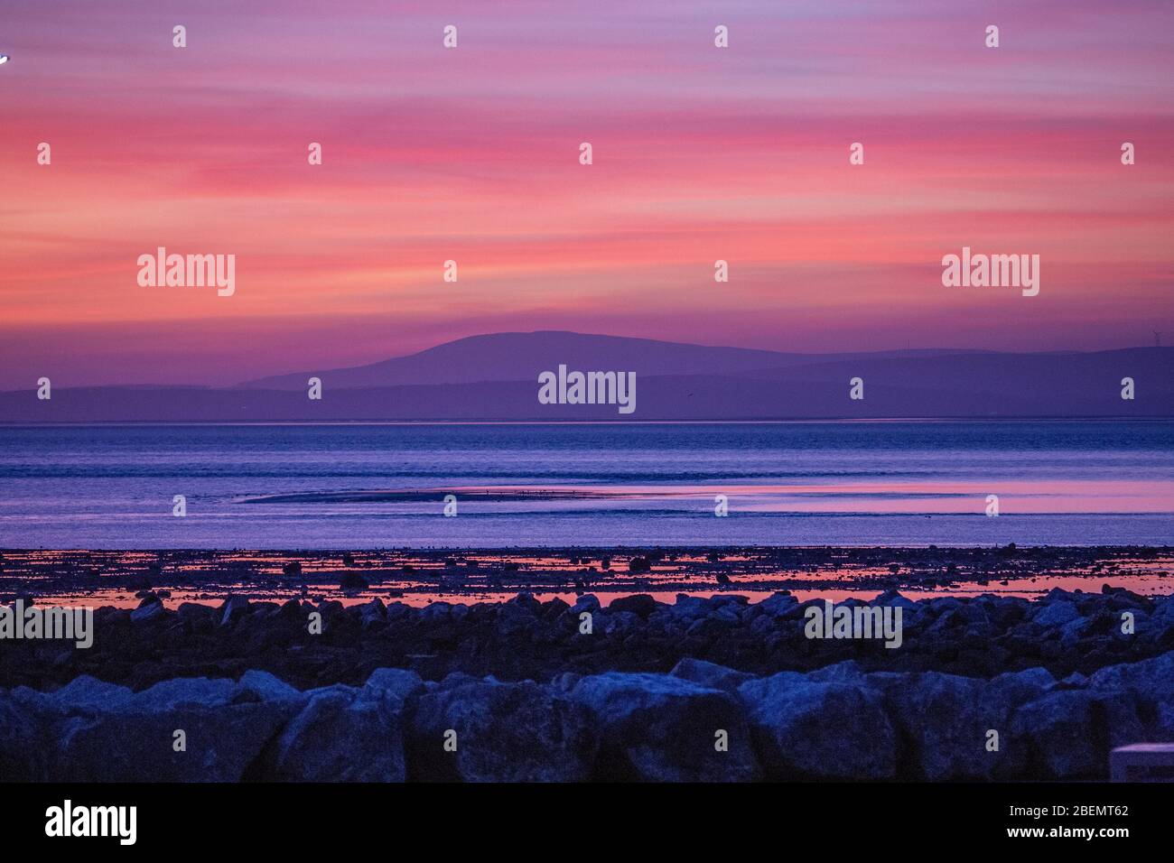 Heysham, Lancashire, United Kingdom. 14th Apr, 2020. Spectacular after glow behind the South Lakeland Fells, across Morecambe Bay brings to a close Tuesday. Credit: Photographing_North/Alamy Live News Stock Photo