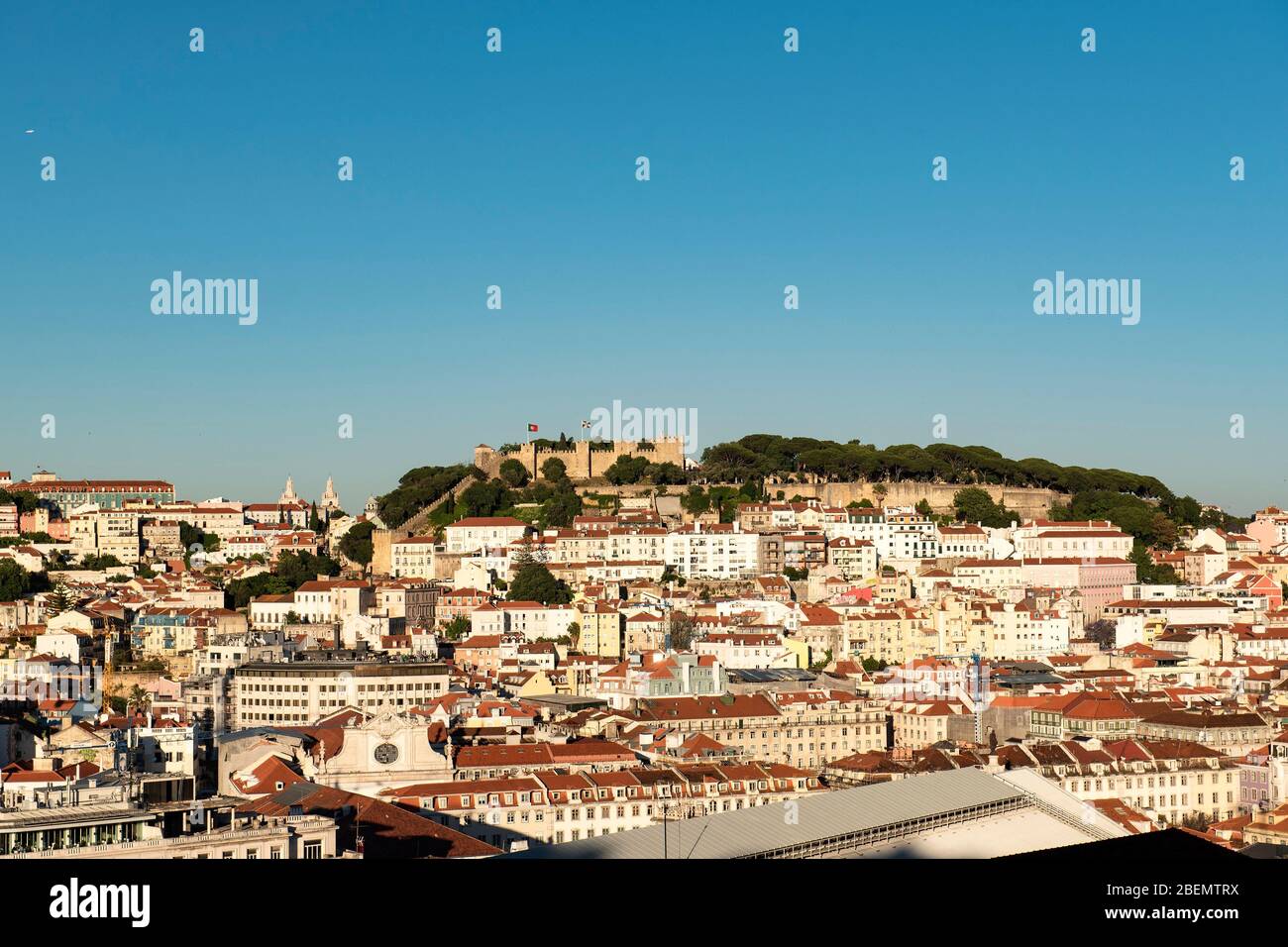 Lisbon, capital of Portugal. Panorama of the city, which is spread over various hills with the castle in the distance, with a blue sky. Stock Photo