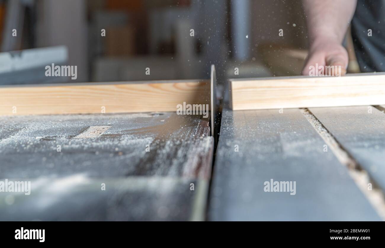 Cutting wooden beam on the circular saw in joinery Stock Photo Alamy