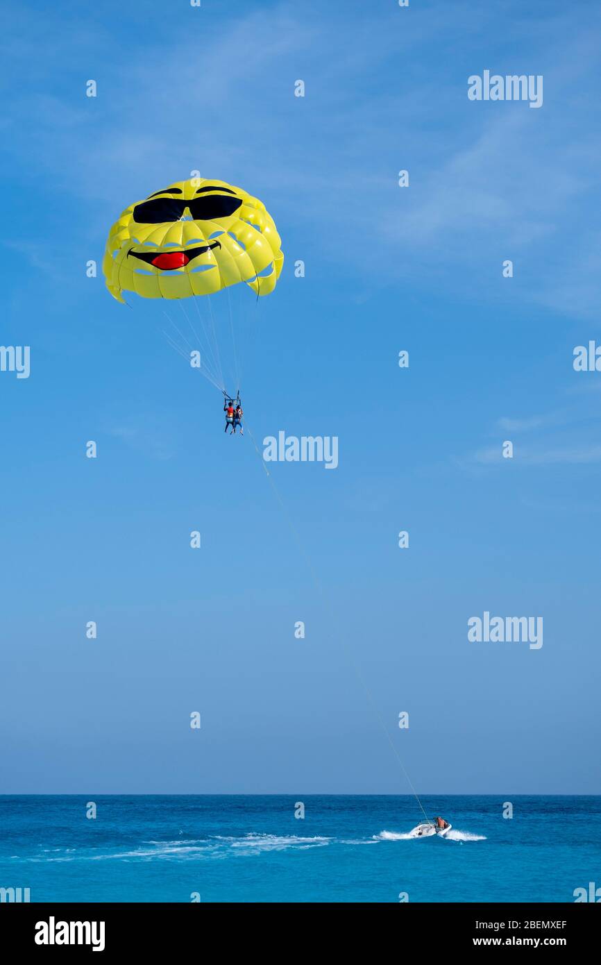 Parasailing couple being pulled by a speedboat Stock Photo