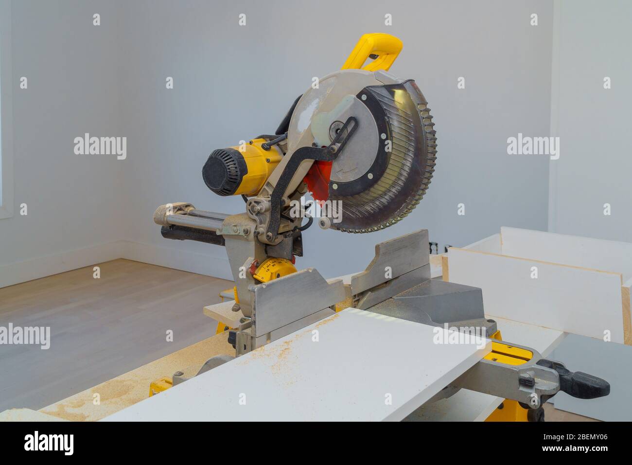 Cut electro saw for cutting wooden laminated white shelves Stock Photo