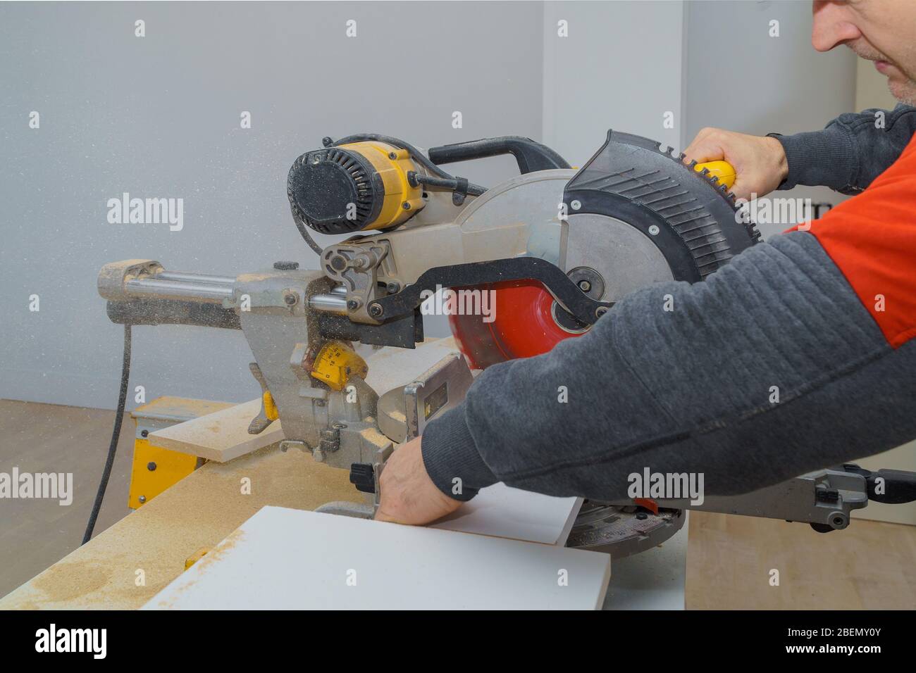 Master cutting circular saw cut a piece of wood laminated shelves in