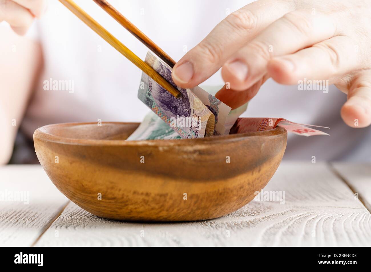 Male hand hold Chinese yuan or abbreviated RMB banknote, the official ...