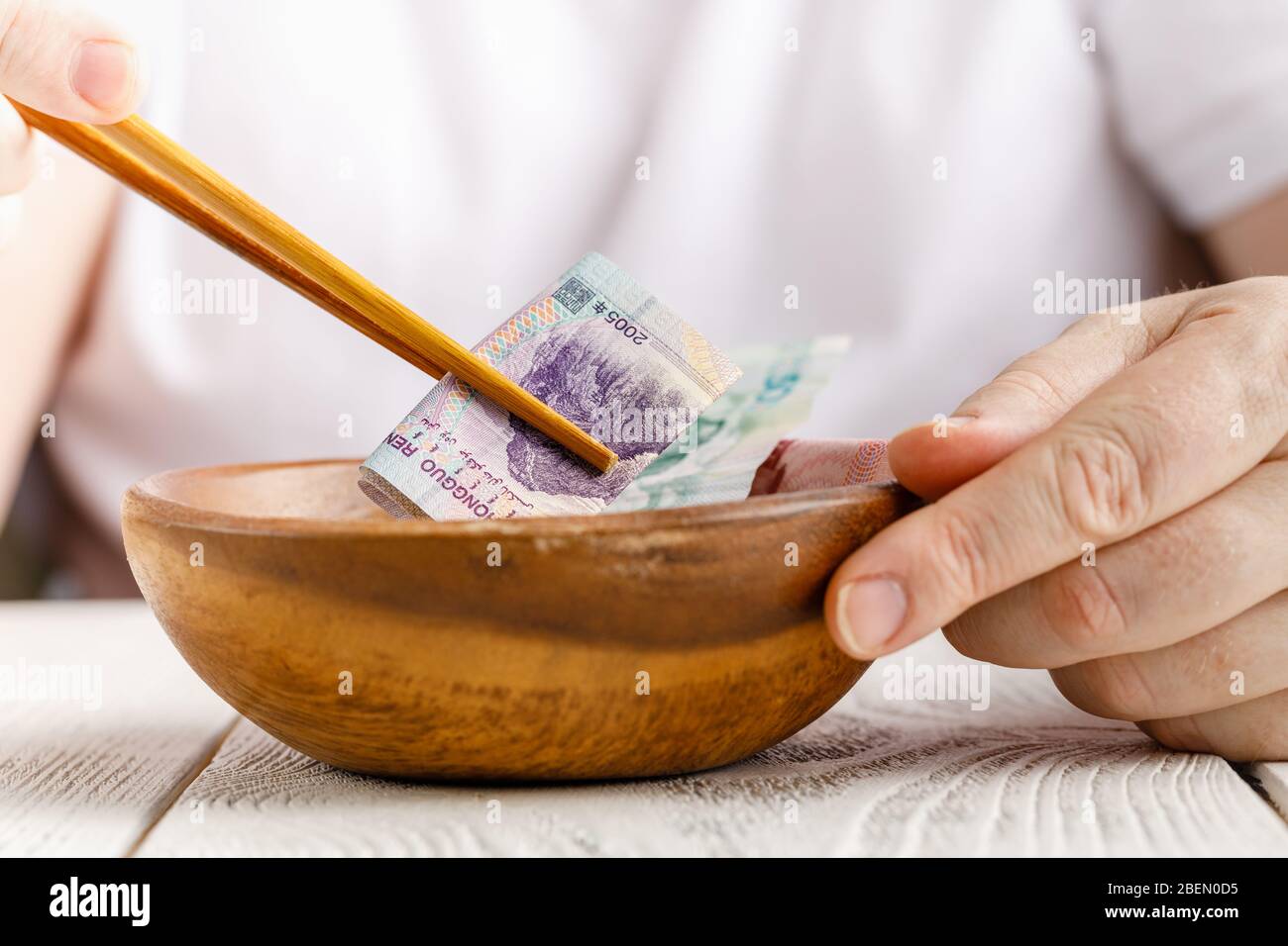 Male hand hold Chinese yuan or abbreviated RMB banknote, the official ...