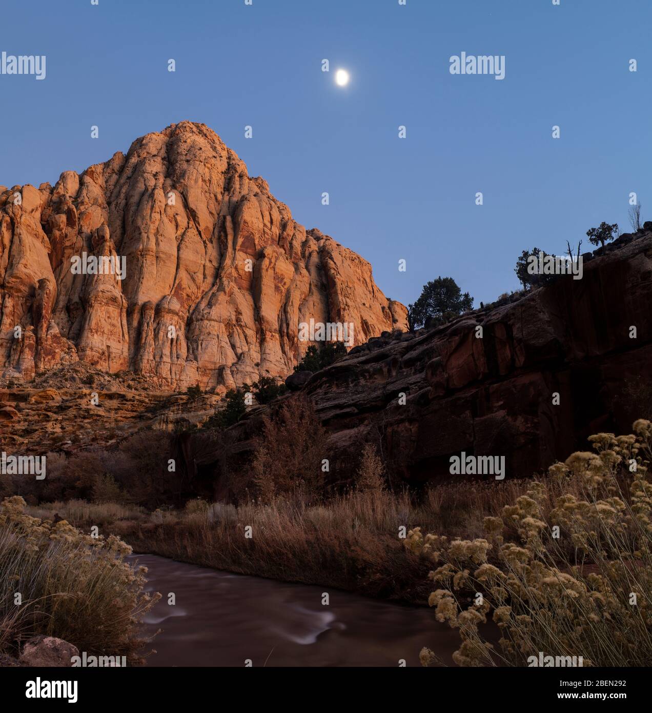 The Moon Rises Behind Pyramid Peak in Capitol Reef National Park Stock Photo