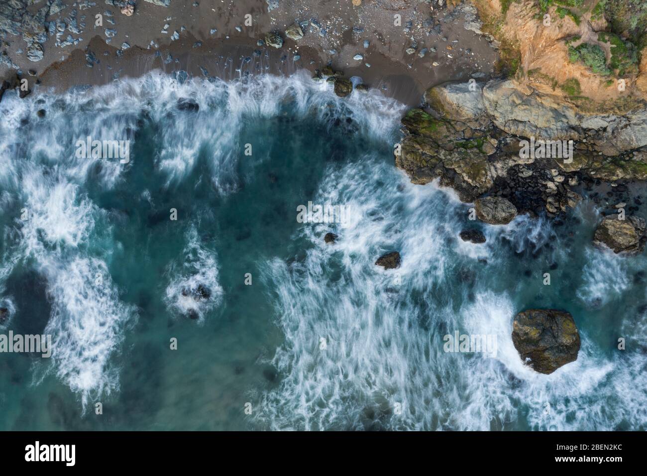 Waves Break on Rugged California Coastline Aerial Stock Photo