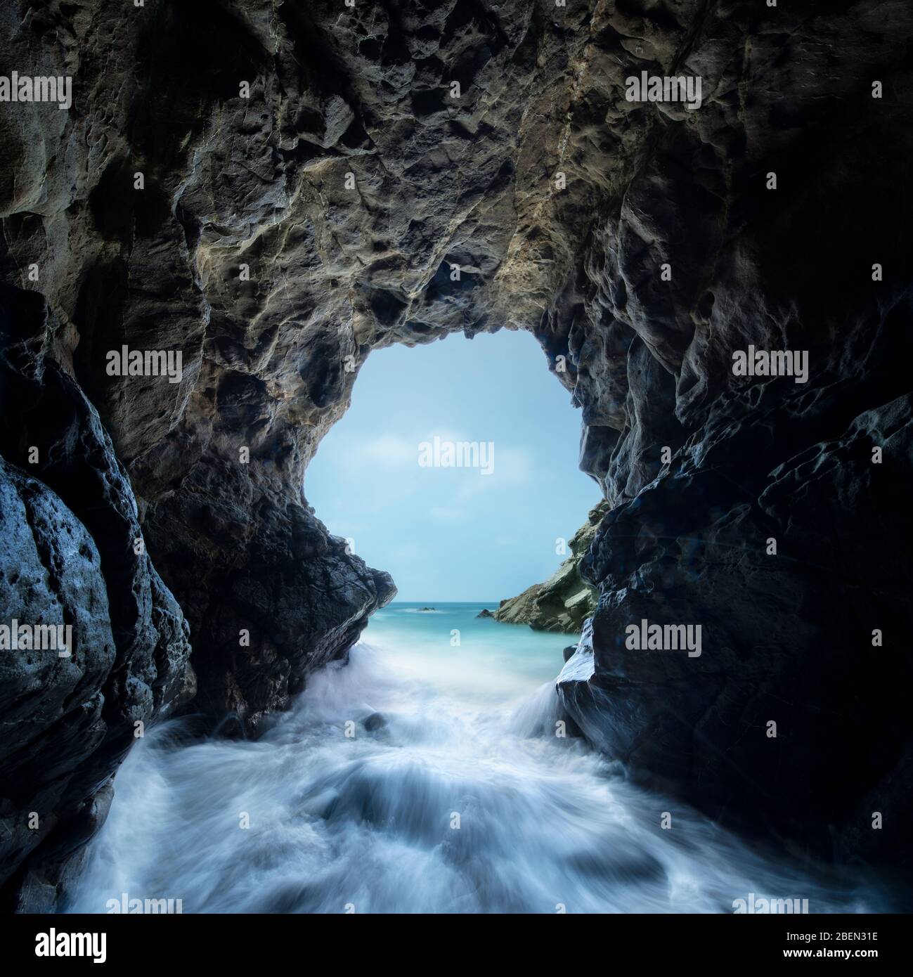 Pacific Waves Crash Through a Sea Cave at Leo Carillo State Park Stock Photo