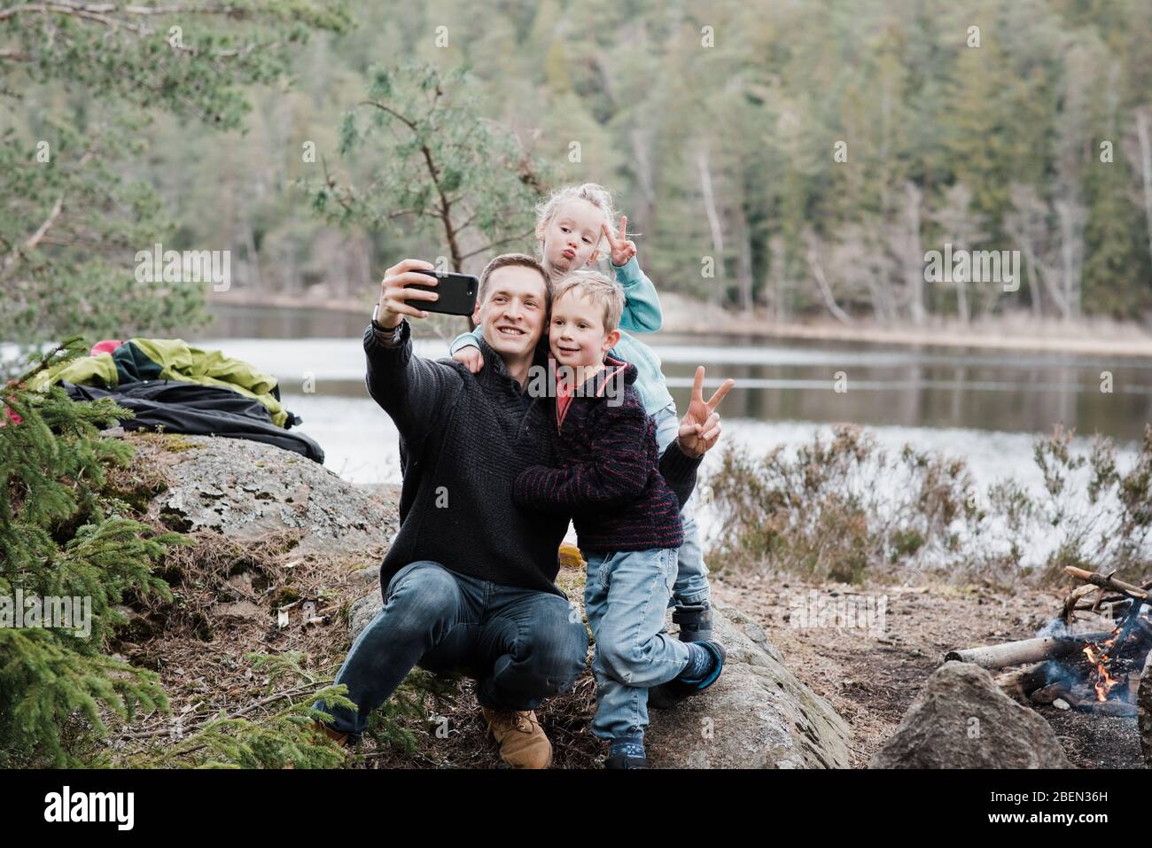 father taking pictures with his kids whilst hiking in Sweden Stock Photo