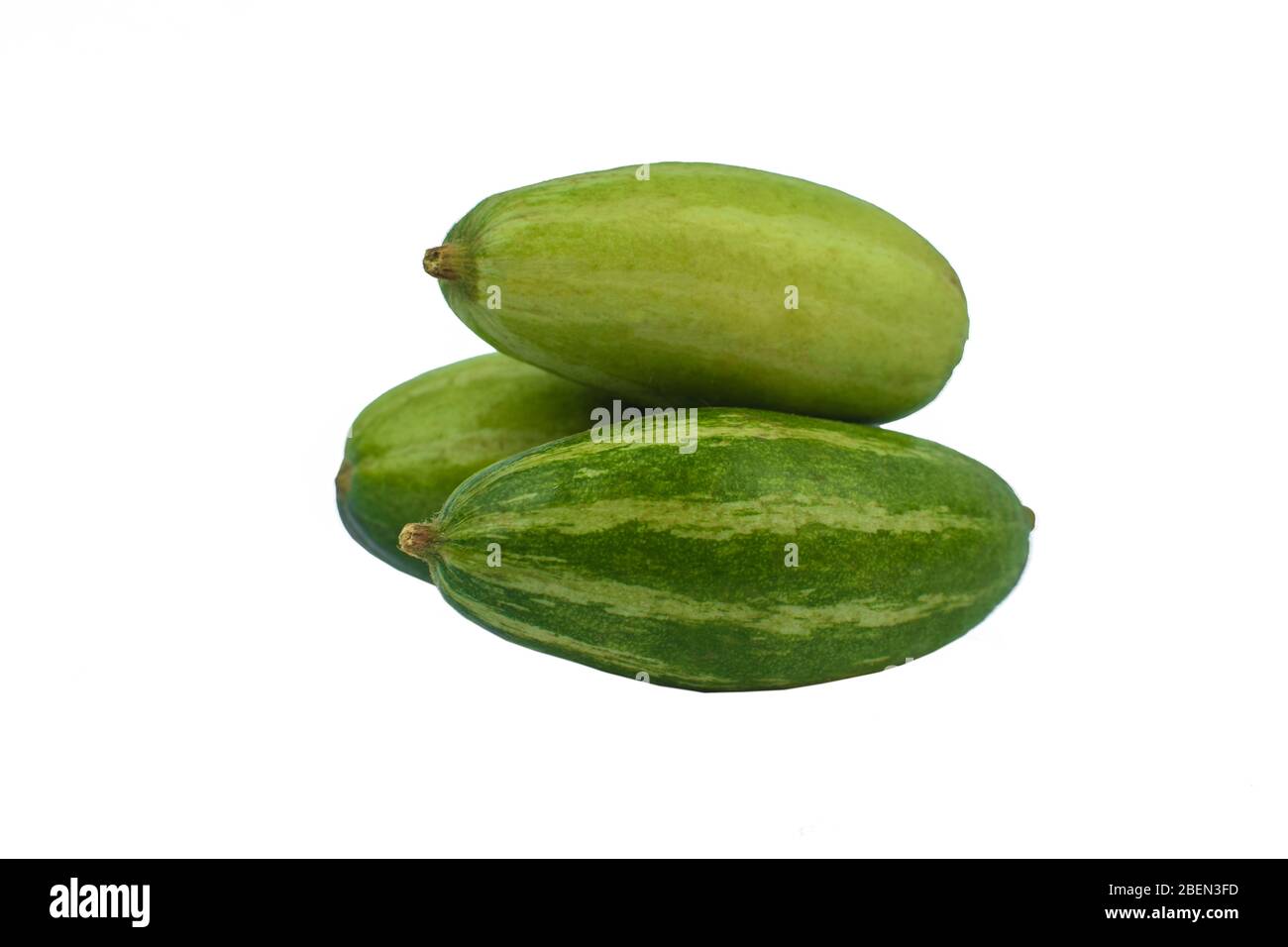 Three fresh green colored pointed gourd stacked on an empty white background Stock Photo