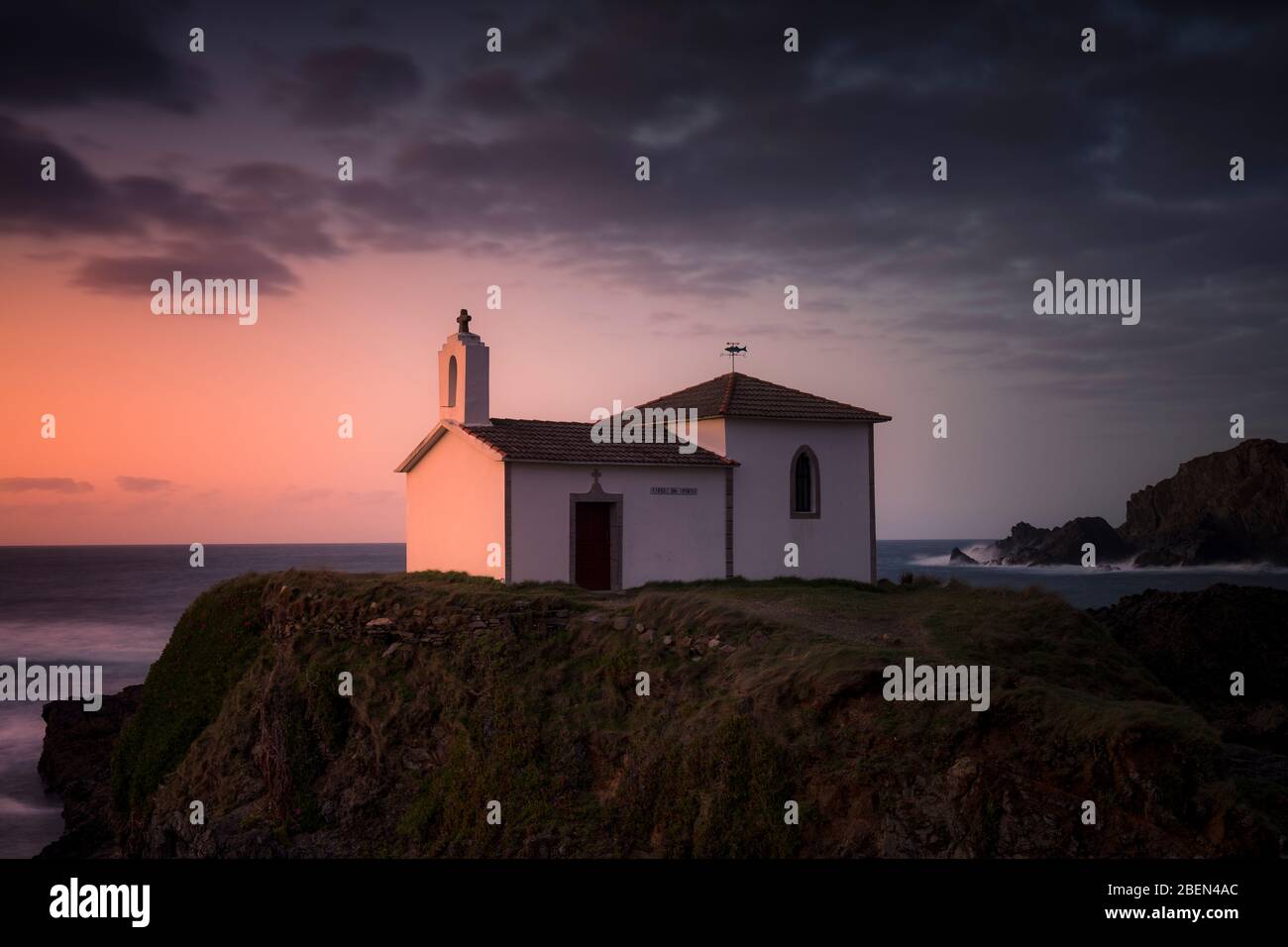 Hermitage on the coast during a dreamlike sunset Stock Photo