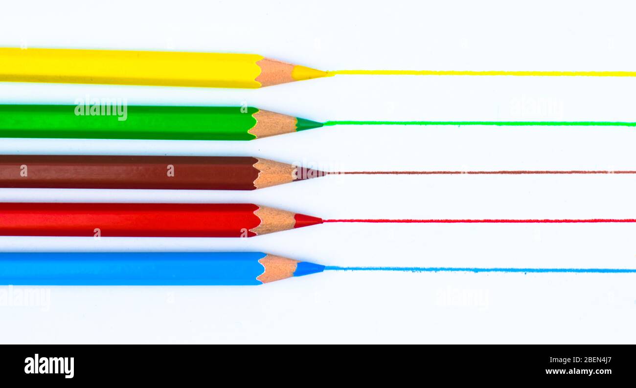 Drawing with five different colored pencil crayon on a white isolated background Stock Photo