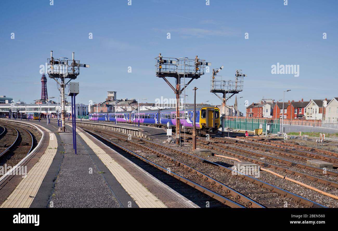 2 Northern rail class 156 sprinter trains departing from Blackpool North station with the bracket semaphore signals Stock Photo