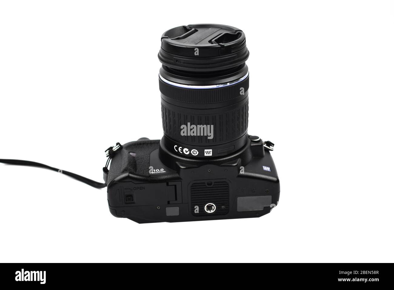 Photograph of a black colored camera with lens attached to it placed on an isolated white background Stock Photo