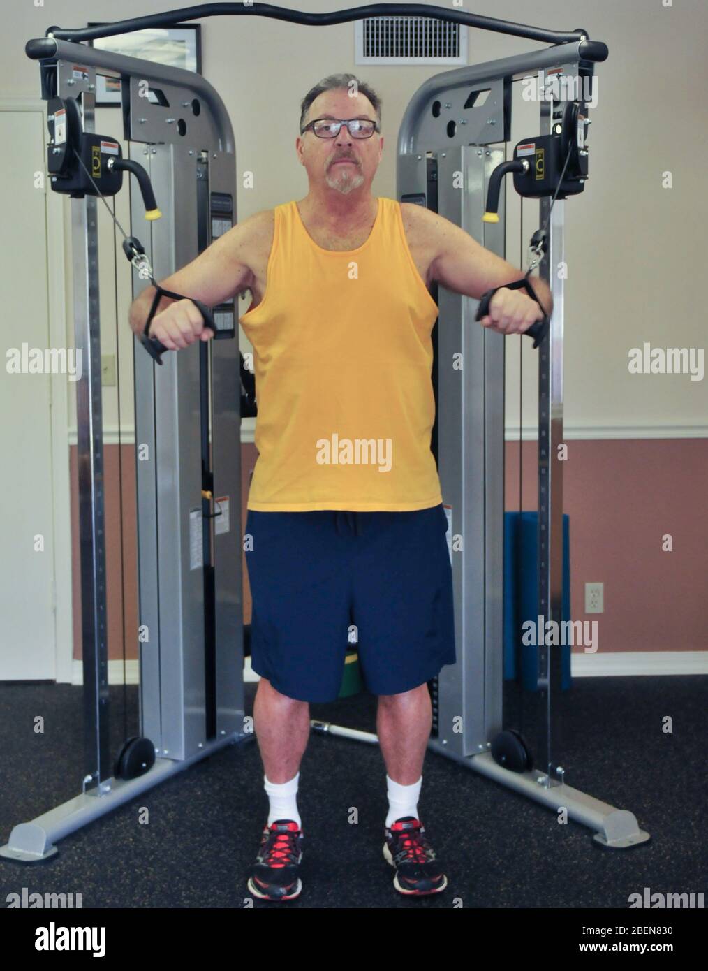 Male senior citizen exercising in a gym Stock Photo