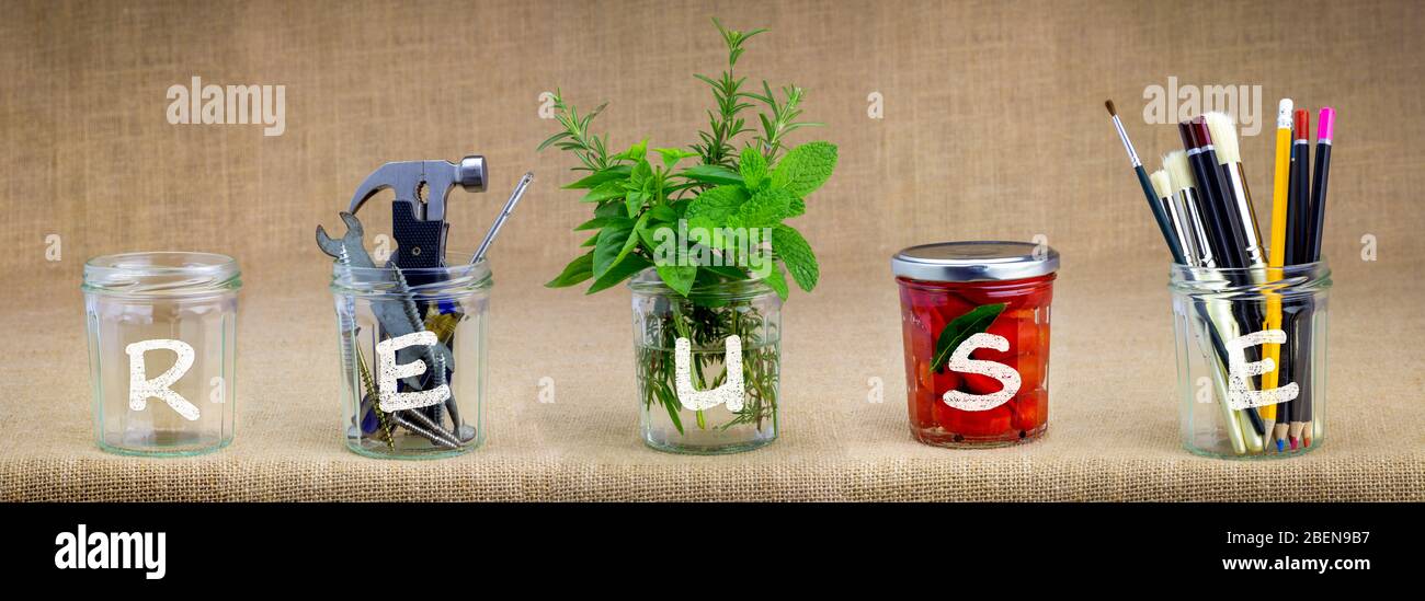 Jars reused with reuse text, recycle and upcycle for sustainable living, save money and zero waste Stock Photo