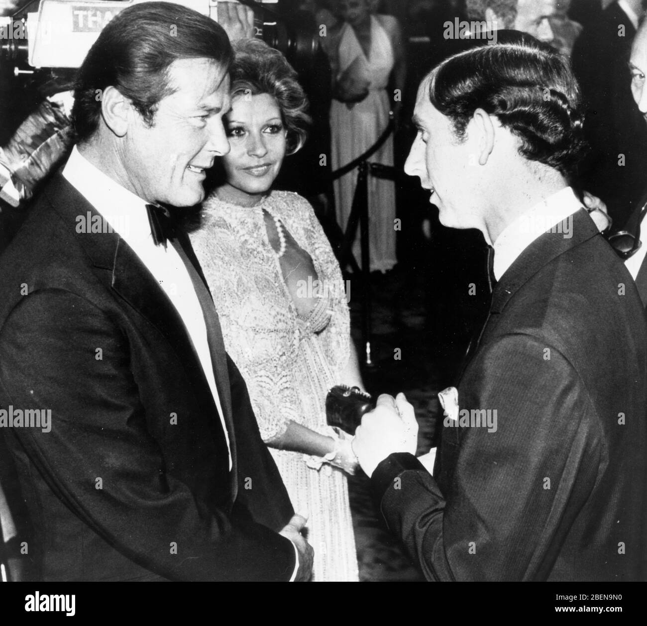 June 25, 1981 - London, England, U.K. - PRINCE CHARLES, right, chats with actor ROGER MOORE, left, and wife LUISA at the premiere of the James Bond film, 'For Your Eyes Only.'  (Credit Image: © Keystone Press Agency/Keystone USA via ZUMAPRESS.com) Stock Photo
