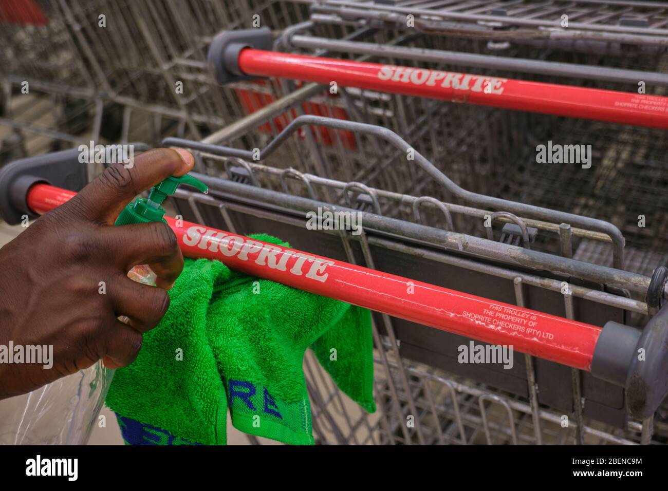 Shopping carts being disinfested at a supermarket during Covid19