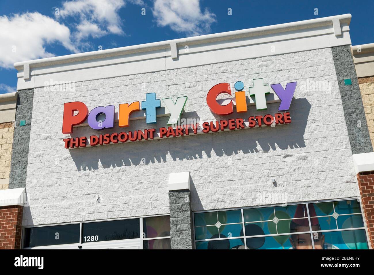 A logo sign outside of a Party City retail store location in Fredericksburg, Virginia on April 2, 2020. Stock Photo