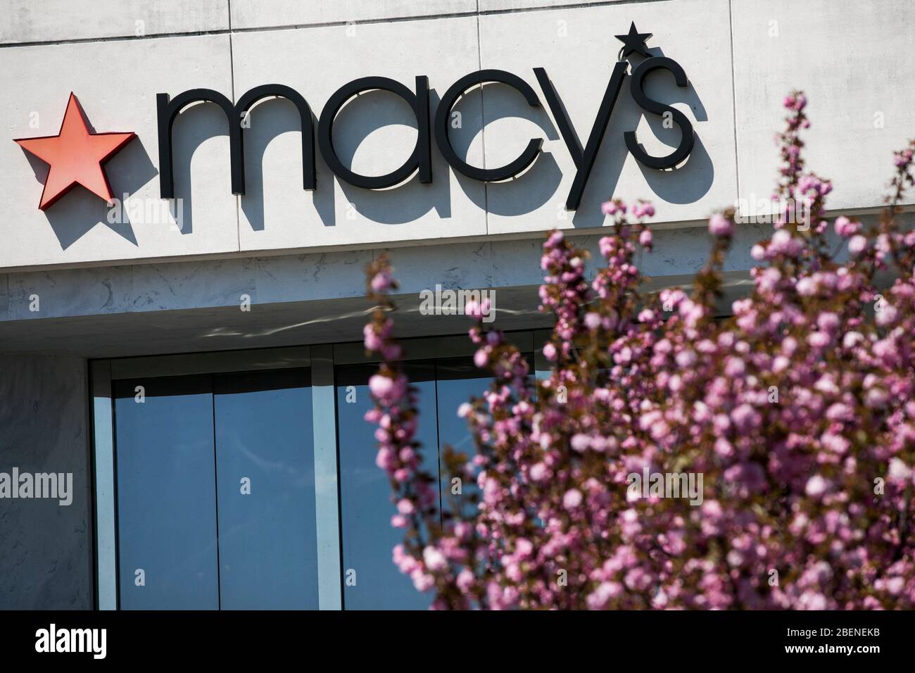 A logo sign outside of a Macy's retail store location in Fredericksburg