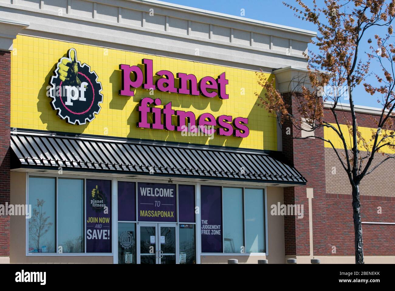A logo sign outside of a Planet Fitness location in Fredericksburg, Virginia on April 2, 2020. Stock Photo