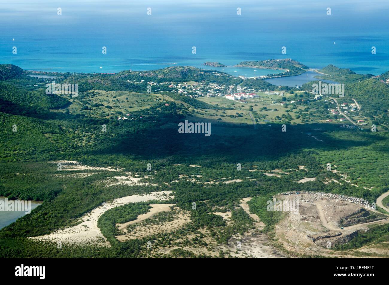 Aerial view of the Caribbean island of Antigua with the white buildings of the Antigua State College, Deep Bay Beach, Fort Barrington National Park an Stock Photo