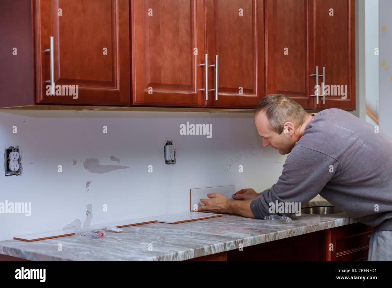 The working tile grouting applying grout to the joint tiles for home