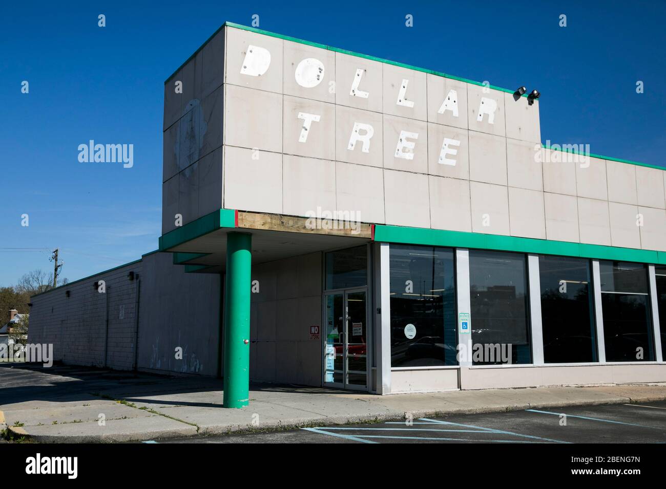 The faded outline of a logo sign outside of a closed and abandoned
