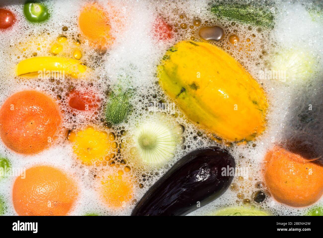 Fruit and vegetables washing in soapy water for coronavirus disinfection. Stock Photo