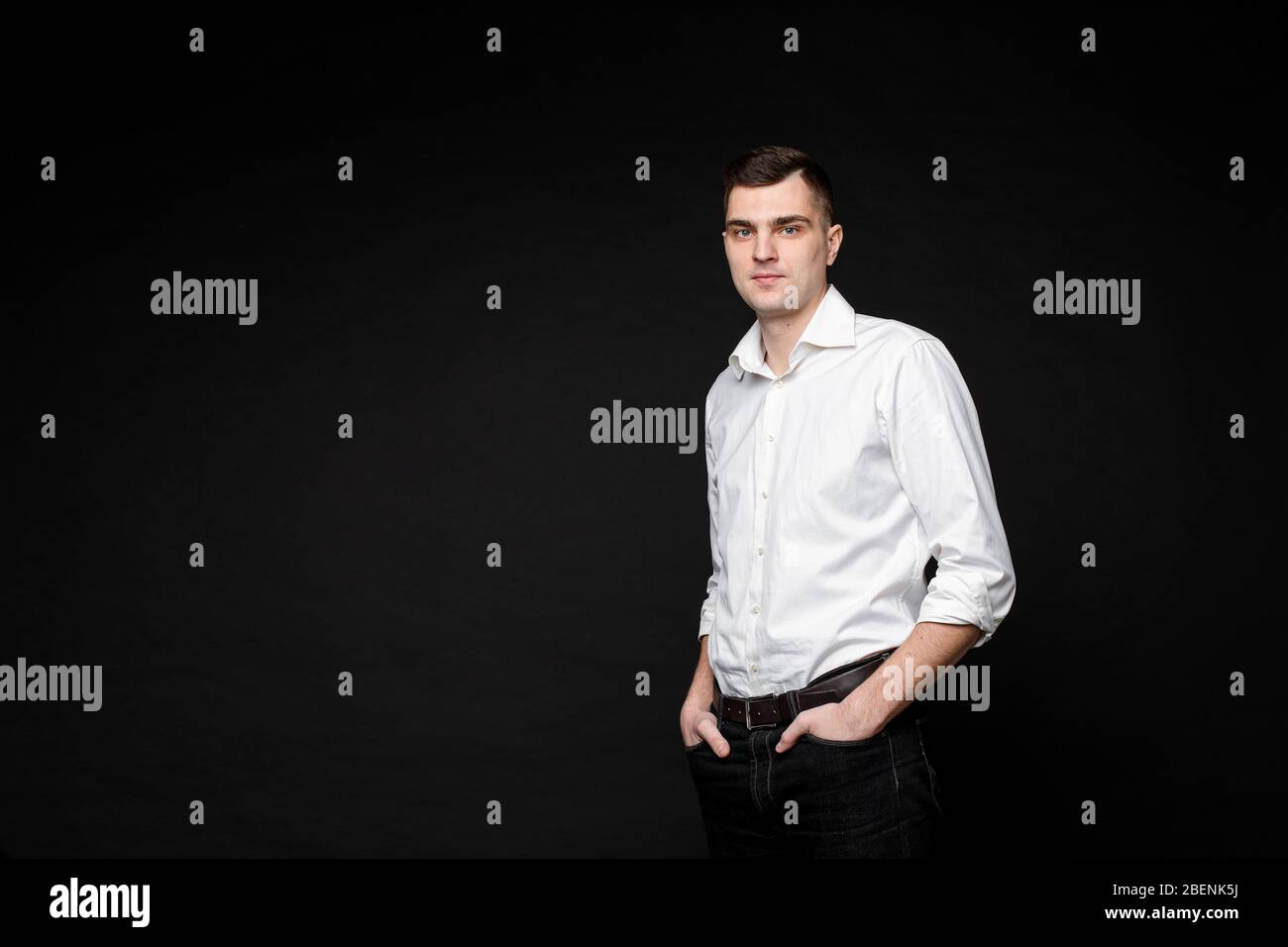 Thoughtful businessman looking at camera in studio Stock Photo