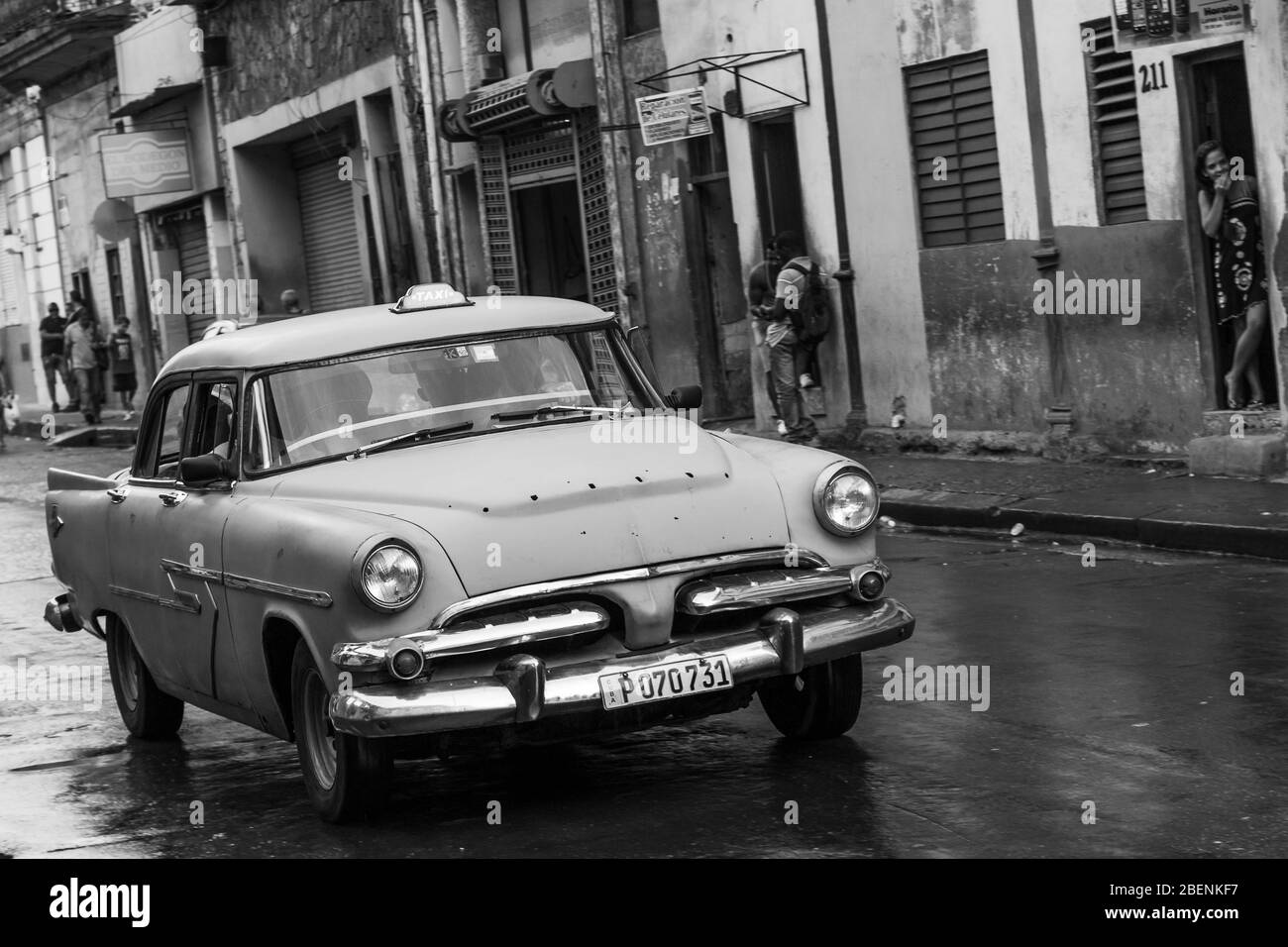 A blue car in excess of sixty years old seen in the rain in Havana (Cuba) during November 2015. Stock Photo