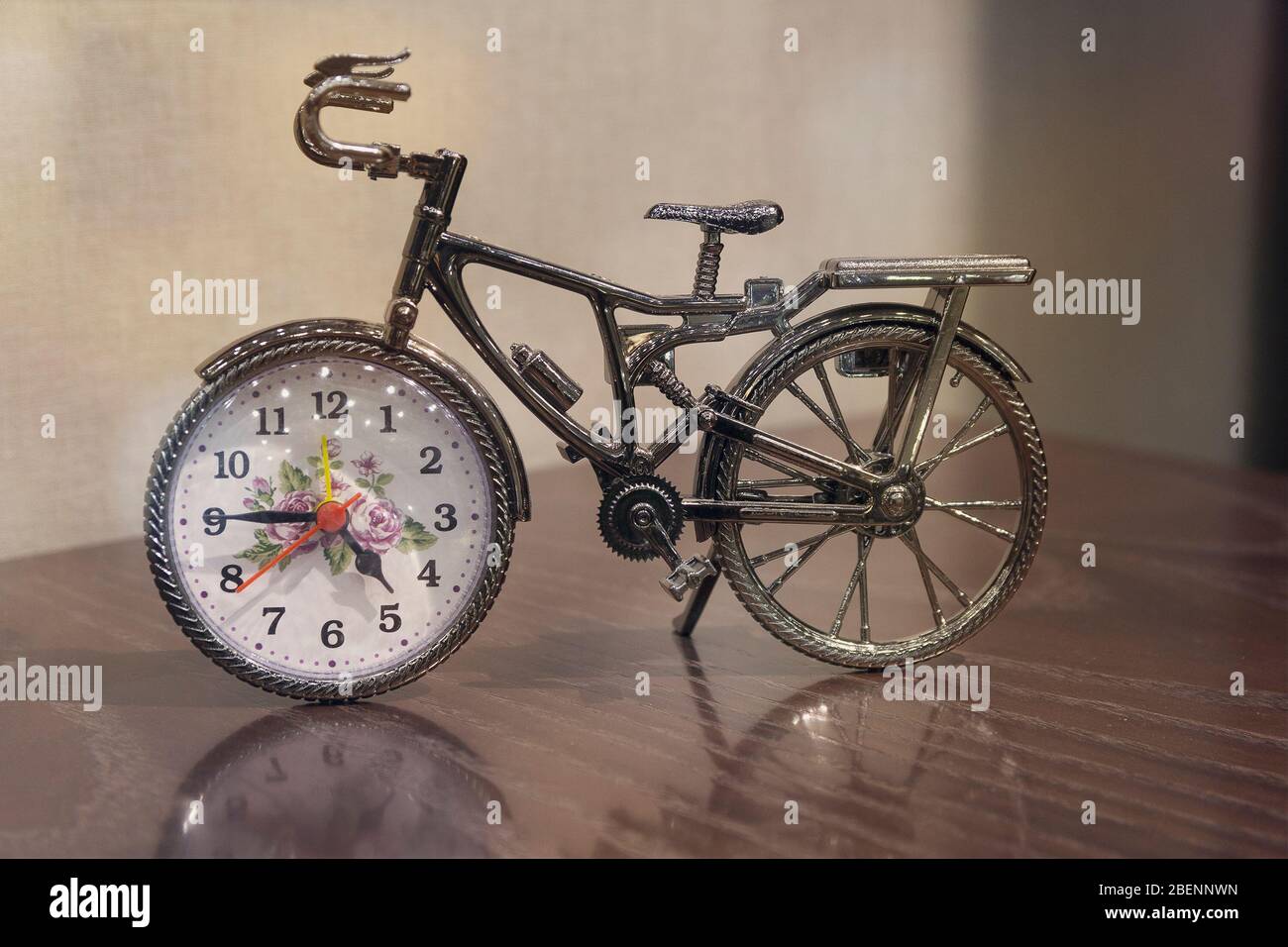 Clock and bicycle of the table. Interior Stock Photo