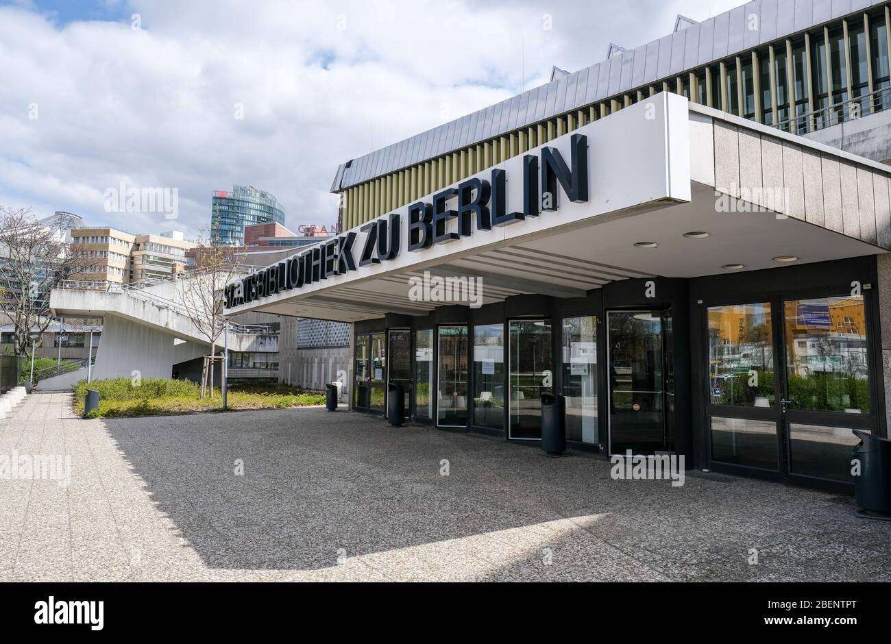14 April 2020, Berlin: The entrance of the Staatsbibliothek zu Berlin at Potsdamer Straße at Potsdamer Platz. The Potsdamer Strasse State Library was built between 1967 and 1978 according to the plans of the architect Hans Scharoun. The Staatsbibliothek zu Berlin - Preußischer Kulturbesitz is the largest scientific universal library in the German-speaking world. It has a main stock of over 11 million books, which are supplemented by about 100,000 units every year, as well as extensive special collections of national and world cultural heritage. Photo: Jens Kalaene/dpa-Zentralbild/ZB Stock Photo