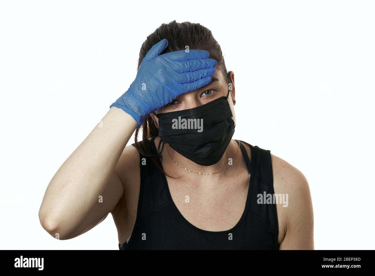 studio shot on white background of a sick young woman wearing mask and ...