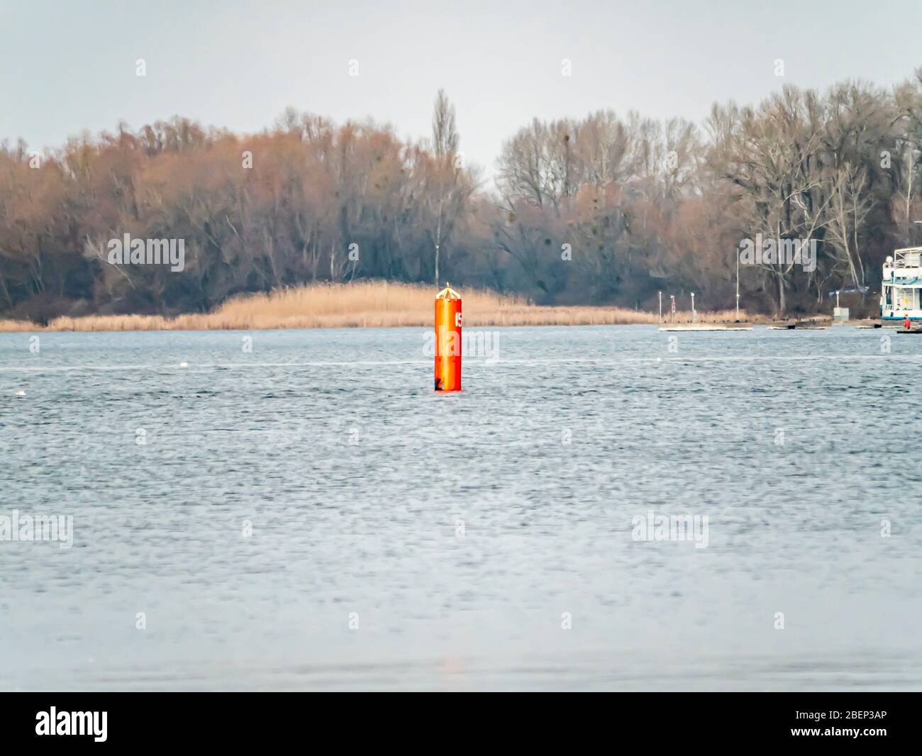 Red buoy designating a channel for navigation on the river Stock Photo