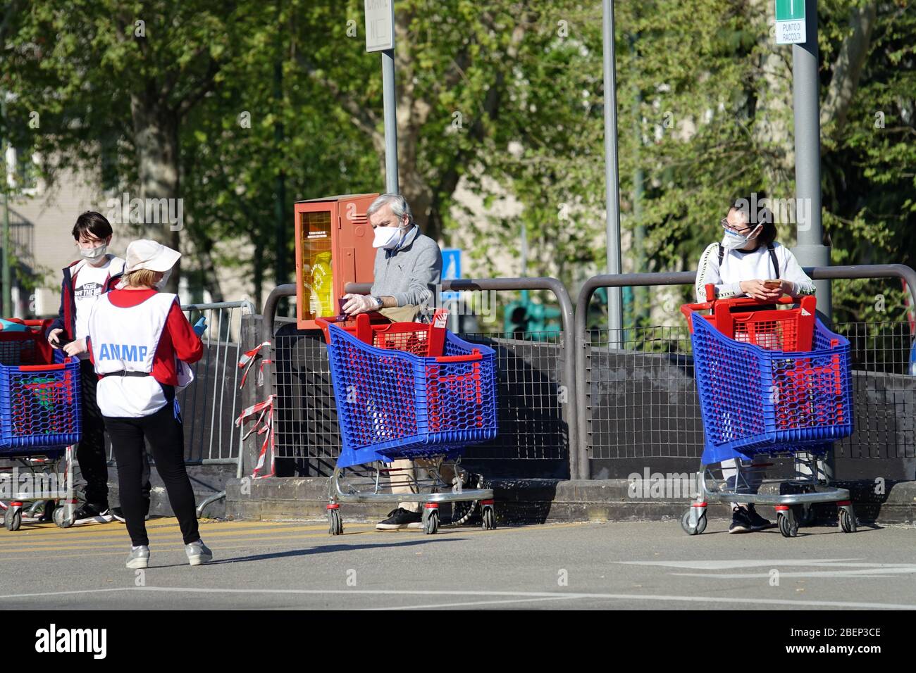 Coronavirus pandemic effects: long queue to enter the supermarket for  shopping. Milan, Italy - April 2020 Stock Photo