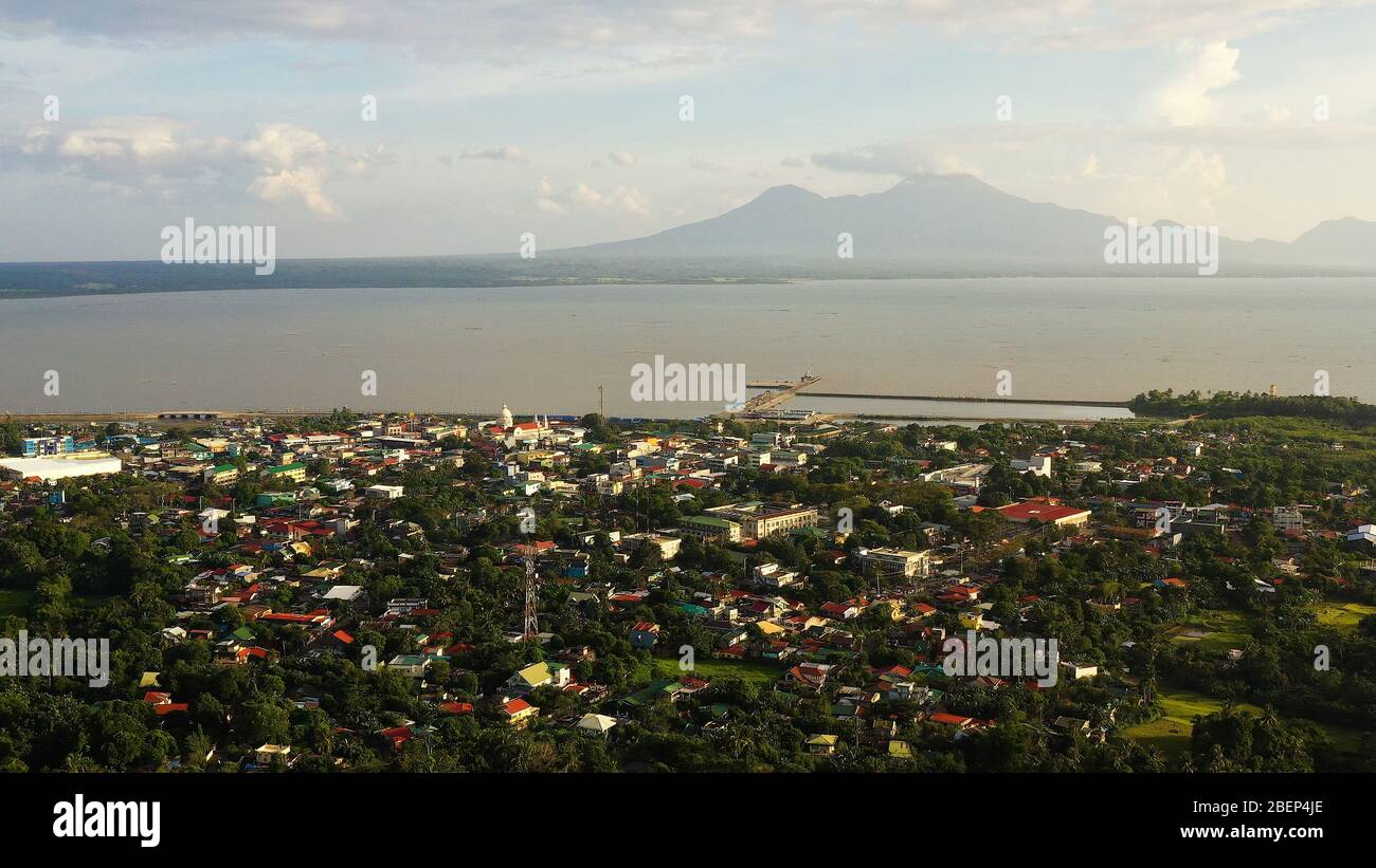 Sorsogon City, Luzon, Philippines. Town by the sea, top view. Landscape in Asia. Summer and travel vacation concept. View of a small town and a volcano in the distance. Stock Photo