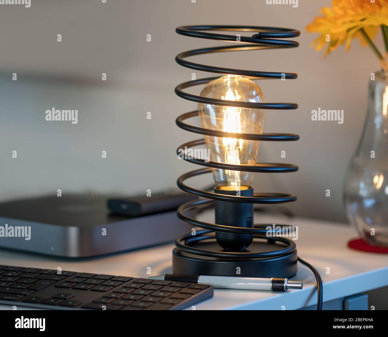 Vintage Iron Spiral Lamp in modern Home Office Environment Close-up View Stock Photo