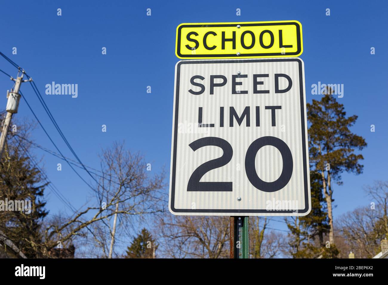Road sign displaying 20 mph speed limit near the school or kindergarten