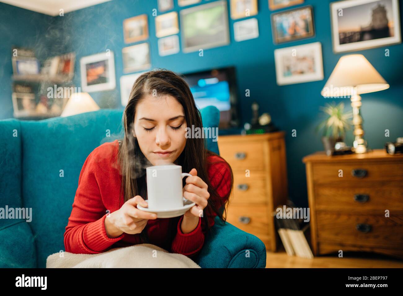 Young woman drinking coffee/tea, spending free time home.Hot beverage for health.Self care,staying home,quarantine.Self-isolation instant coffee.Start Stock Photo