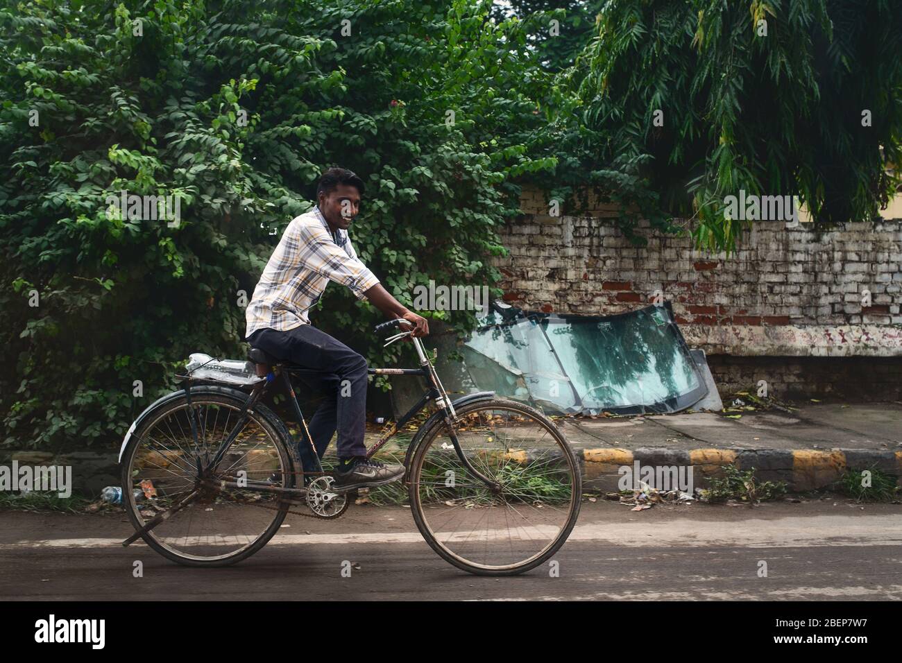 Boy riding a bike in Varanasi, India Stock Photo