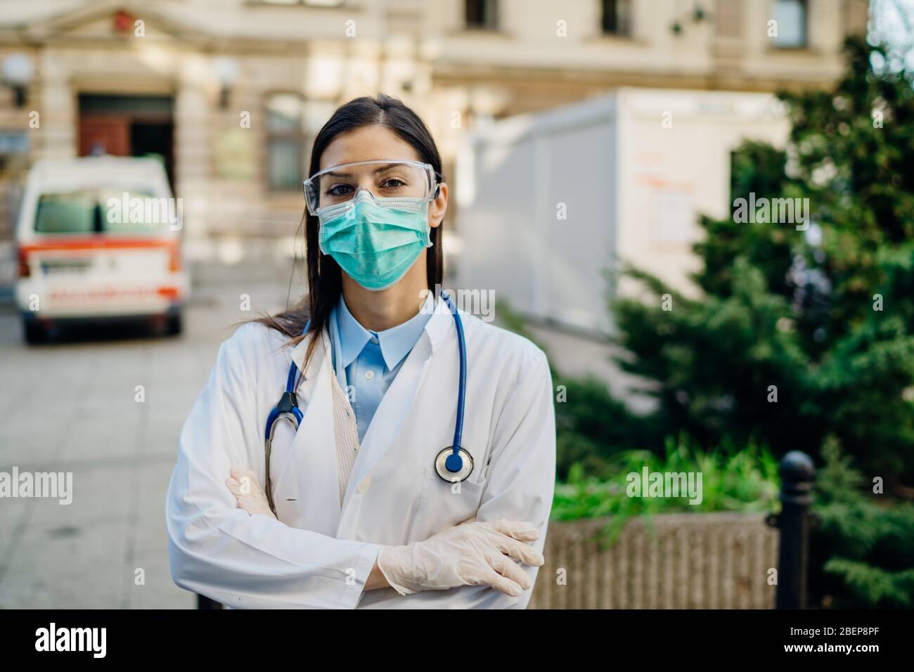 Brave optimistic paramedic in the front lines,working in a isolation hospital facility with infected patients.Covid-19 emergency room triage doctor wi Stock Photo