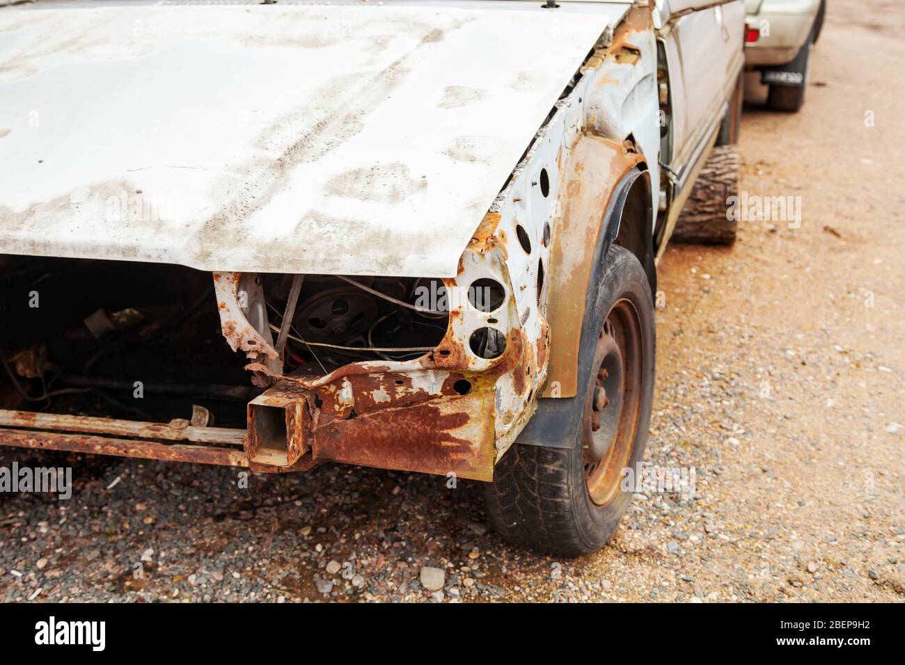 Old abandoned wrecked car. The front part of a disassembled passenger