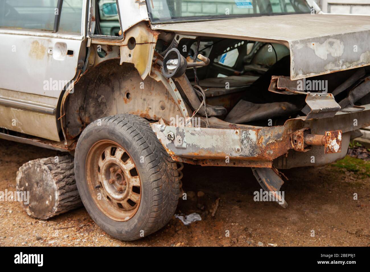 Old abandoned wrecked car. The back of a disassembled passenger car of
